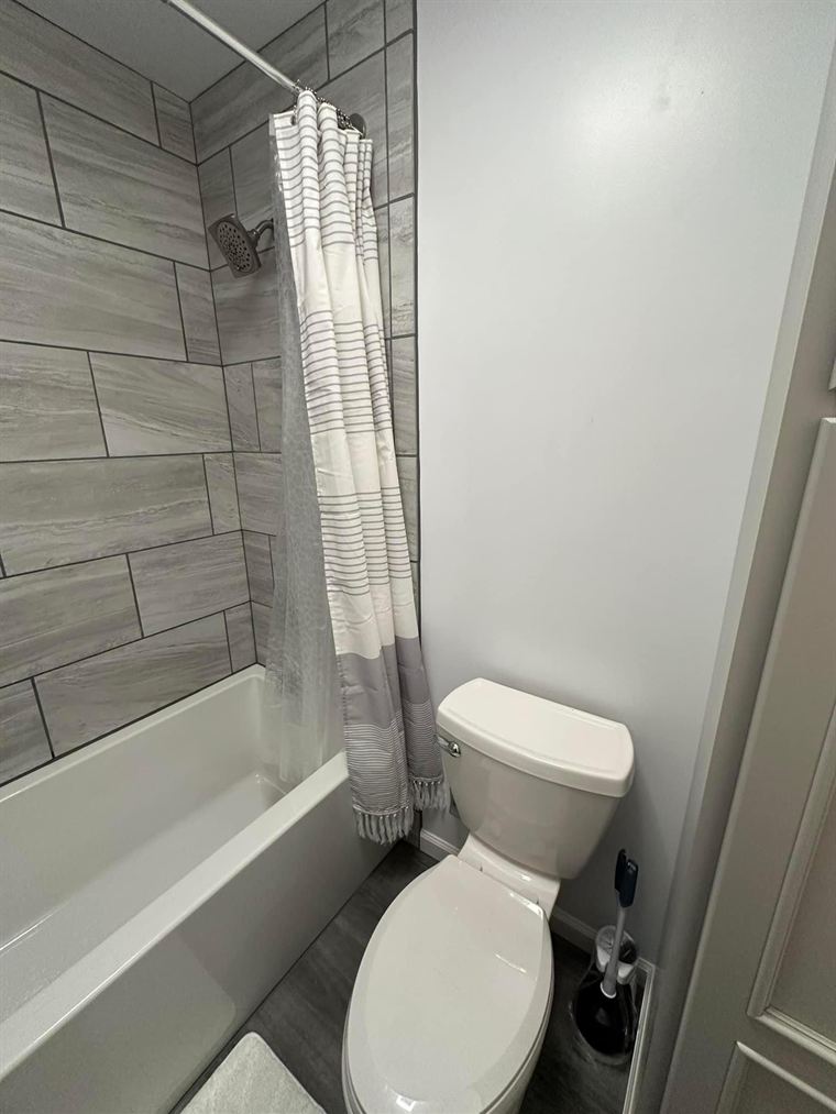 New tub with a tiled surround and new flooring